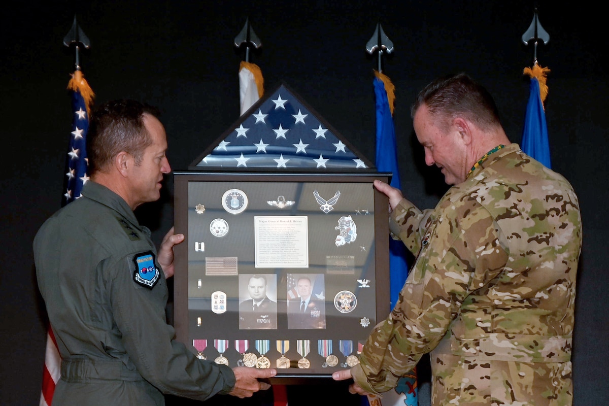 Lt. Gen. David Iverson, Commander, 7th Air Force, left, presents a shadow box to Maj. Gen. Daniel Heires, Mobilization Assistant to the Commander, Air Component Command, United Nations Command; Commander, Air Component Command, Combined Forces Command; and Commander, 7th AF, right, during General Heires’ retirement ceremony at Osan Air Base, Republic of Korea, March 15, 2024.