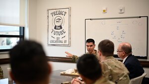 U.S. Air Force Maj. Gen. Matteo Martemucci, Deputy Chief, Central Security Service, National Security Agency, sits down and eats lunch with 316th Training Squadron instructors and military training leaders at the Cressman Dining Facility at Goodfellow Air Force Base, Texas Feb. 29, 2024. The 316th TRS is home to all the cryptologic training for the Air Force and most cryptologic analysts across the Department of Defense. (U.S. Air Force photo by Airman 1st Class Brian Lummus)