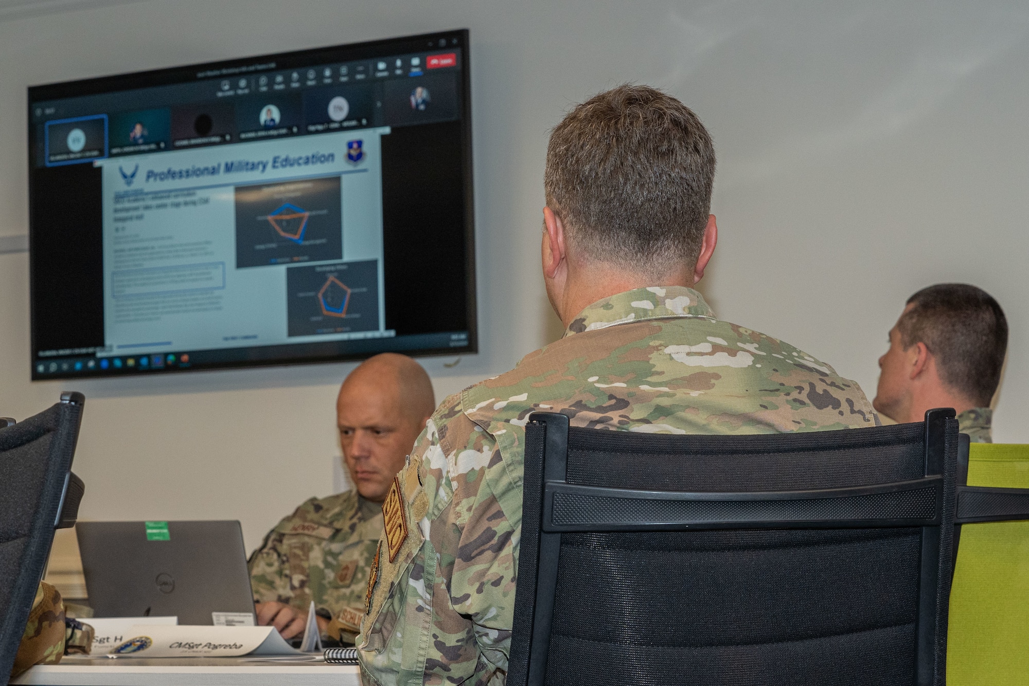 A U.S. Air Force Airman observes the slides regarding professional military education at the joint weather workshop on Keesler Air Force Base, Mississippi, March 13, 2024.