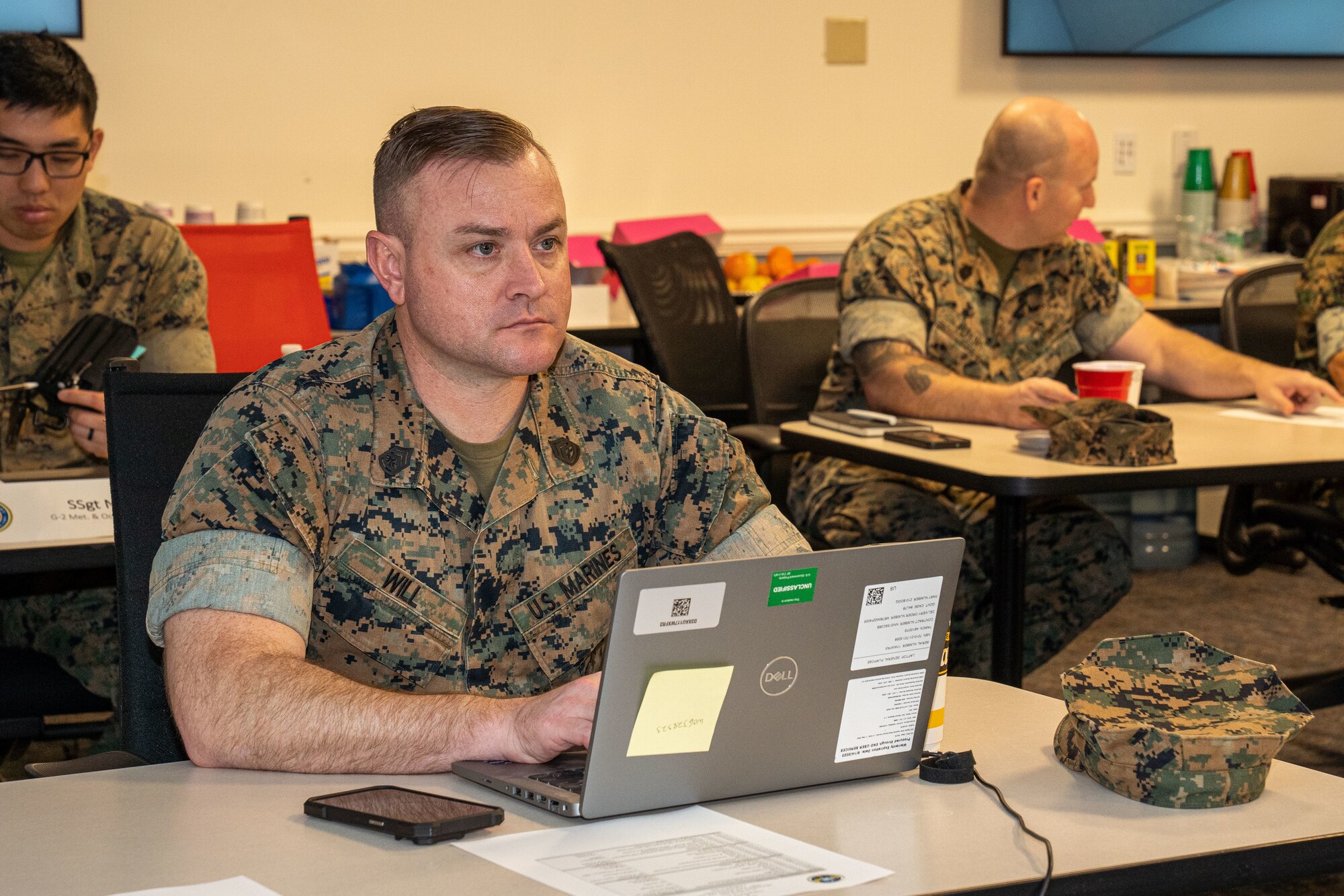 A U.S. Marine listens to how the weather specialist initial skills training course is changing at the joint weather workshop on Keesler Air Force Base, Mississippi, March 12, 2024.