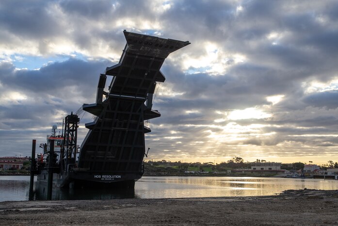 The Stern Landing Vessel, a modified oil-rig industry off-shore support vessel, prepares to drop its ramp onto the beach in order to load cargo as part of Project Convergence Capstone 4, Feb. 22, 2024 at the Del Mar Boat Basin, Camp Pendleton, CA. The Marine Corps Warfighting Laboratory contracted the SLV to experiment with maneuver and sustainment options for Stand-In Forces to inform the development of the Medium Landing Ship (LSM). PC-C4 is an Army-hosted, all-Service and multinational experiment. During PC-C4, the Marine Corps Warfighting Laboratory tested new technologies and capabilities and emerging concepts, including the multi-domain corridor. Marine Corps participation in PC-C4 supported Force Design initiatives, integrated Joint force and coalition capabilities into experimentation, and demonstrated the Marine Corps' commitment to the Joint Warfighting Concept. (U.S. Marine Corps photo by Cpl. Trent Henry)