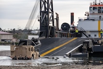 A Joint Light Tactical Vehicle drives onto the Stern Landing Vessel at the Del mar Boat Basin at Camp Pendleton, CA., during Project Convergence Capstone 4. The Marine Corps Warfighting Laboratory contracted the SLV to experiment with maneuver and sustainment options for Stand-In Forces to inform the development of the Medium Landing Ship (LSM). PC-C4 is an Army-hosted, all-Service and multinational experiment. During PC-C4, the Marine Corps Warfighting Laboratory tested new technologies and capabilities and emerging concepts, including the multi-domain corridor. Marine Corps participation in PC-C4 supported Force Design initiatives, integrated Joint force and coalition capabilities into experimentation, and demonstrated the Marine Corps' commitment to the Joint Warfighting Concept. (U.S. Marine Corps photo by Lance Cpl. Mhecaela Watts)