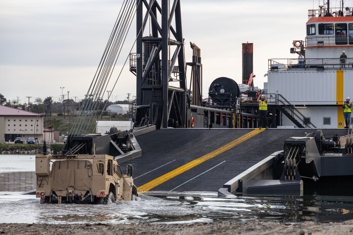 A Joint Light Tactical Vehicle drives onto the Stern Landing Vessel at the Del mar Boat Basin at Camp Pendleton, CA., during Project Convergence Capstone 4. The Marine Corps Warfighting Laboratory contracted the SLV to experiment with maneuver and sustainment options for Stand-In Forces to inform the development of the Medium Landing Ship (LSM). PC-C4 is an Army-hosted, all-Service and multinational experiment. During PC-C4, the Marine Corps Warfighting Laboratory tested new technologies and capabilities and emerging concepts, including the multi-domain corridor. Marine Corps participation in PC-C4 supported Force Design initiatives, integrated Joint force and coalition capabilities into experimentation, and demonstrated the Marine Corps' commitment to the Joint Warfighting Concept. (U.S. Marine Corps photo by Lance Cpl. Mhecaela Watts)