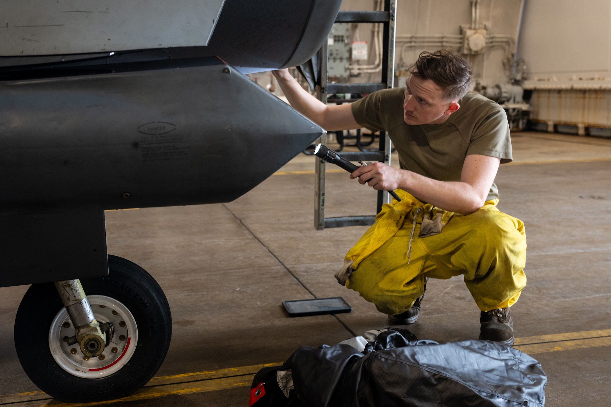 U.S. Air Force Staff Sgt. Tyler Miller, 36th Fighter Generation Squadron crew chief, inspects the air intake of an F-16 Fighting Falcon during the Ninja Mustang training event at Misawa Air Base, Japan, March 6, 2024. Ninja Mustang displayed the agile combat employment abilities of the 51st Fighter wing as well as the ability to combine fighter squadrons and generate air power. The 36th FGS displayed their lethality by sending limited manpower and resources and ensuring that two F-16 Fighting Falcons were properly maintained and fully mission capable for three days. (U.S. Air Force photo by Airman 1st Class Chase Verzaal)