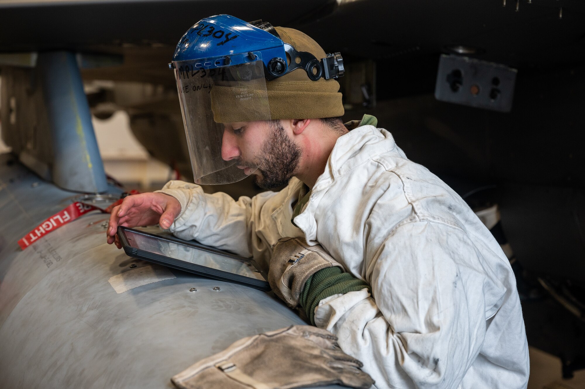 U.S. Air Force Staff Sgt. Sergio Sanchez, 36th Fighter Generation Squadron electrical and environmental technician, reads instructions from technical orders during the Ninja Mustang training event at Misawa Air Base, Japan, March 6, 2024. Ninja Mustang allows the 51st FW to develop the lethality and readiness of its Airmen in the event of strategic relocation to deter potential threats. The event involved participation from the 51st Fighter Wing and the 13th Fighter Squadron, to test the operational capabilities of the 51st FW after relocating to other bases within the pacific. (U.S. Air Force photo by Airman 1st Class Chase Verzaal)