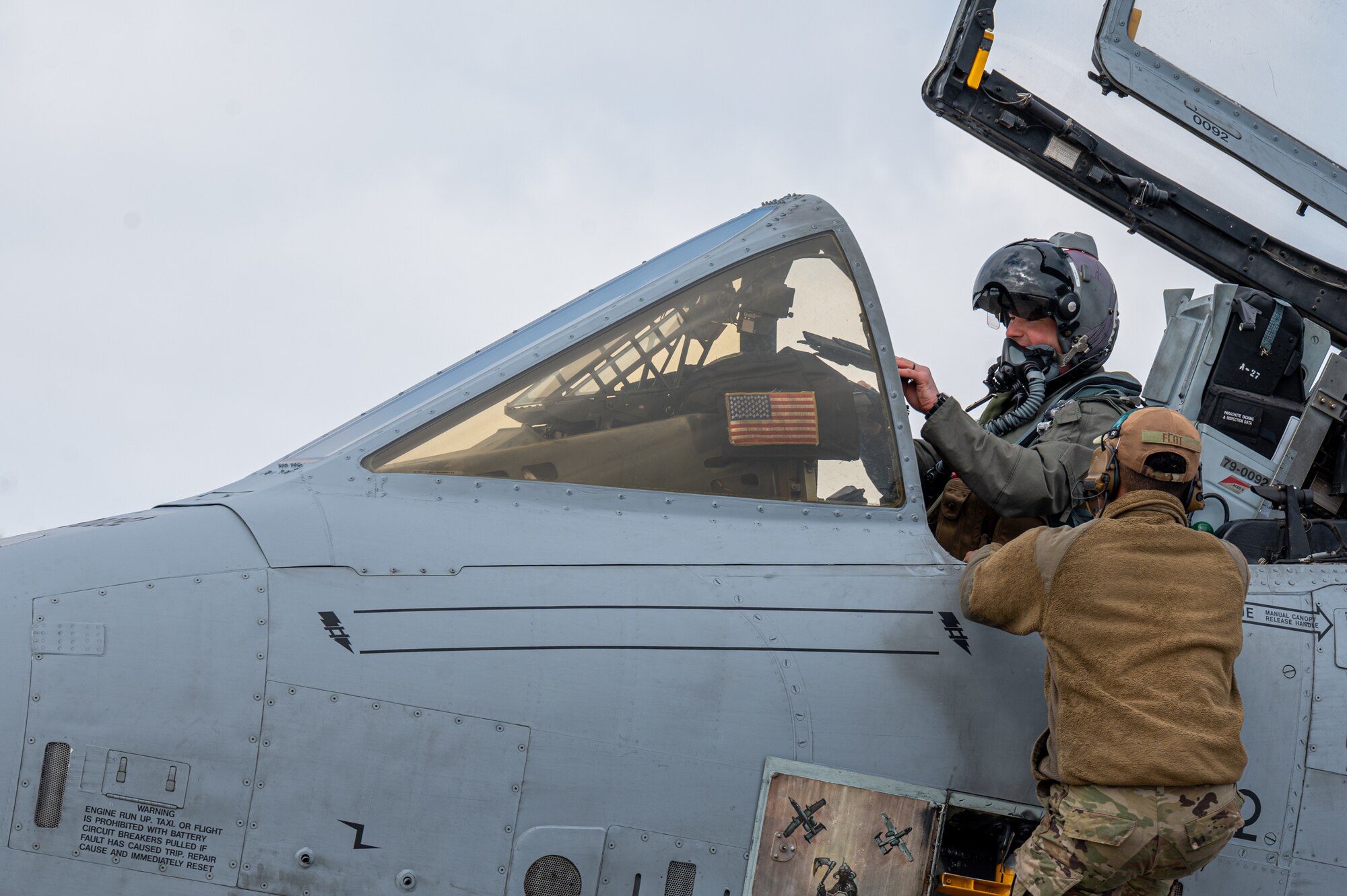 U.S. Air Force Lt. Col. Justin Ledvina, 25th Fighter Squadron director of operations, and Senior Airman Bryan Flot, 25th Fighter Generation Squadron airframe, powerplant and general Technician, prepare for a flight during the Ninja Mustang training event at Misawa Air Base, Japan, March 7, 2024.  Ninja Mustang is a training event within the Ninja Draggin series, where 51st FW Airmen relocate to collaborate with units across the Pacific. This initiative enhances the lethality and coordination of units within the pacific theater. The 51st Fighter Wing proved their lethality through conducting the training event and executing the “Fight Tonight” mission in an unfamiliar location with limited resources. (U.S. Air Force photo by Airman 1st Class Chase Verzaal)