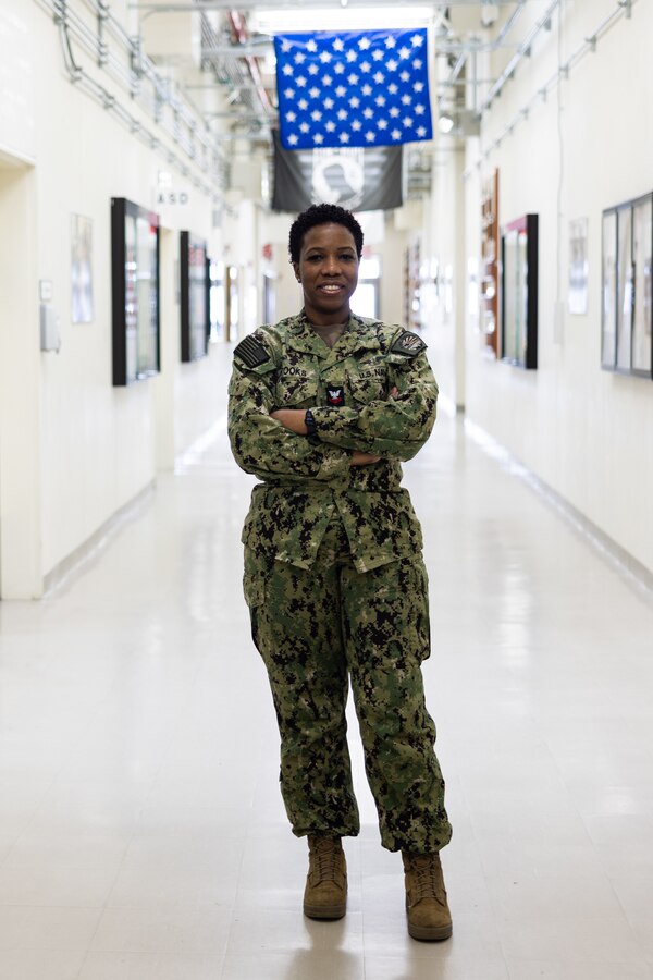 U.S. Navy Aviation Support Equipment Technician Second Class Patrice Brooks, a native of Jamaica, with Aircraft Intermediate Maintenance Department (AIMD) Iwakuni, poses for a picture at MCAS Iwakuni, Japan, Feb. 16, 2024. As the command career counselor for AIMD Iwakuni and president of CSADD, Brooks holds a responsibility to ensure all Sailors under her guidance are well prepared to advance their careers and be valuable contributors to the community. (U.S. Marine Corps photo by Cpl. Isaac Orozco)