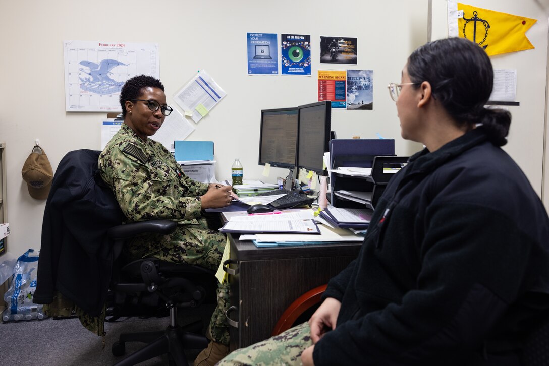U.S. Navy Aviation Support Equipment Technician Second Class Patrice Brooks, a native of Jamaica, and Aviation Electrician’s Mate First Class Celeste Taylor, a Texas native, both with Aircraft Intermediate Maintenance Department (AIMD), Iwakuni, discuss potential career paths at MCAS Iwakuni, Japan, Feb. 16, 2024. As the command career counselor for AIMD Iwakuni and president of the Coalition of Sailors Against Destructive Decisions, Brooks holds a responsibility to ensure all Sailors under her guidance are well prepared to advance their careers and be valuable contributors to the community. (U.S. Marine Corps photo by Cpl. Isaac Orozco)