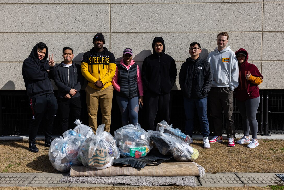 Members of the Coalition of Sailors Against Destructive Decisions (CSADD) pose for a picture in front of their collected trash from a volunteer event at MCAS Iwakuni, Japan, Feb. 25, 2024. As the command career counselor for AIMD Iwakuni and president of CSADD, Brooks holds a responsibility to ensure all Sailors under her guidance are well prepared to advance their careers and be valuable contributors to the community. (U.S. Marine Corps photo by Cpl. Isaac Orozco)