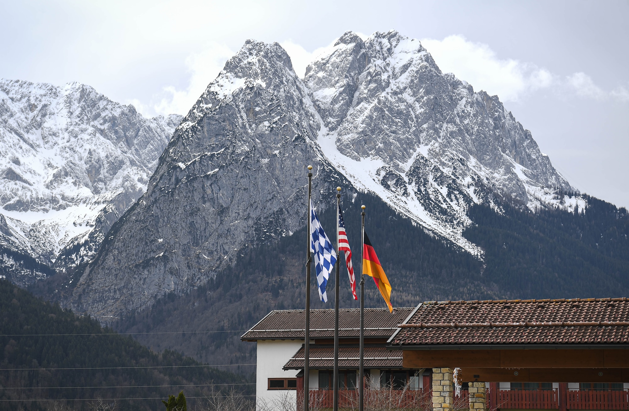 Flags wave in the wind during a marriage retreat at Edelweiss Lodge and Resort at Garmisch-Partenkirchen, Germany, March 3, 2024. The location of the marriage retreat offered various outdoor activities such as hiking and skiing. (U.S. Air Force photo by Senior Airman Jared Lovett)