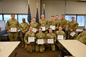 Newly inducted noncommissioned officers (NCO) pose for a group photo during the NCO induction ceremony at Hancock Field Air National Guard Base, Syracuse, NY March 9, 2024