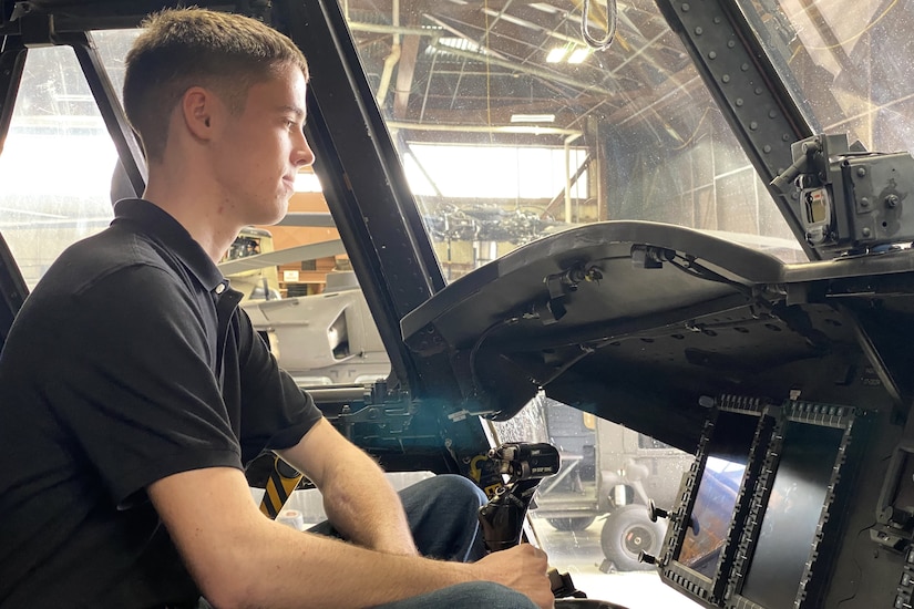 Isaac Bell, a Pennsylvania Army National Guard recruit who enlisted through the 09W program, checks our the cockpit of a CH-47 Chinook helicopter during an enlistment and swearing-in ceremony at Muir Army Heliport at Fort Indiantown Gap, Pennsylvania, March 15, 2024. The 09W program, also known as “streets to seats” or “high school to flight school” provides a path to flight school after basic training for enlistees who are selected in a rigorous selection process. (U.S. Army National Guard photo by Maj. Travis Mueller)