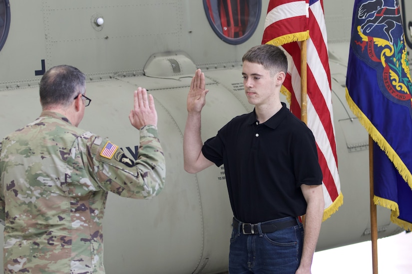 Isaac Bell, a Pennsylvania Army National Guard recruit who enlisted through the 09W program, takes the oath of enlistment during an enlistment and swearing-in ceremony at Muir Army Heliport at Fort Indiantown Gap, Pennsylvania, March 15, 2024. The 09W program, also known as “streets to seats” or “high school to flight school” provides a path to flight school after basic training for enlistees who are selected in a rigorous selection process. (U.S. Army National Guard photo by Maj. Travis Mueller)