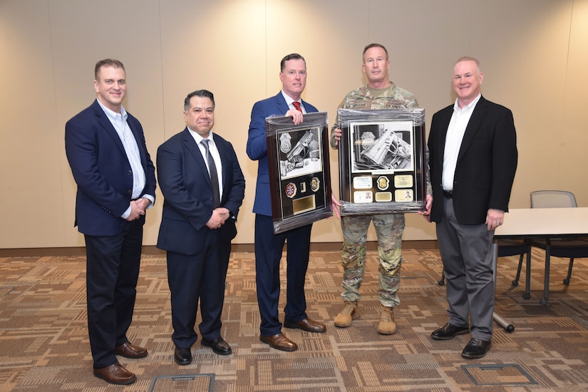 Army CID officials presented service recognition awards to two retiring members of the 200th MP Command.