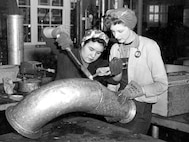 Sheetmetal Shop 17 workers Pearl Sanchez and Mary St. Sauveur solder pipe, sometime between 1942 and 1945. In 1942, there were 80 women working in the shipyard’s industrial area. By December 1944, there were 4,266. They personified the “Rosie the Riveter” cultural icon of the era. (U.S. Navy photo)