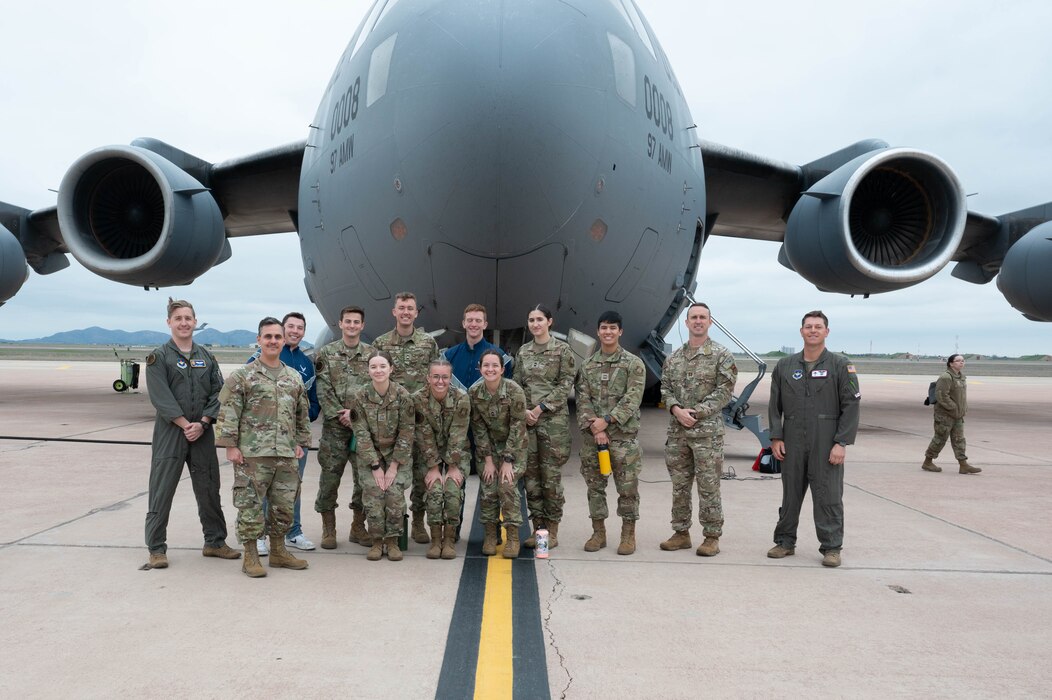 Aircrew from the 58th Airlift Squadron and Air Force ROTC (AFROTC) cadets, pose for a photo in front of a C-17 Globemaster III during a tour at Altus Air Force Base, Oklahoma, March 15, 2024. The AFROTC cadets had their first orientation flight to experience the mission of the Mighty 97th. (U.S. Air Force photo by Airman 1st Class Heidi Bucins)