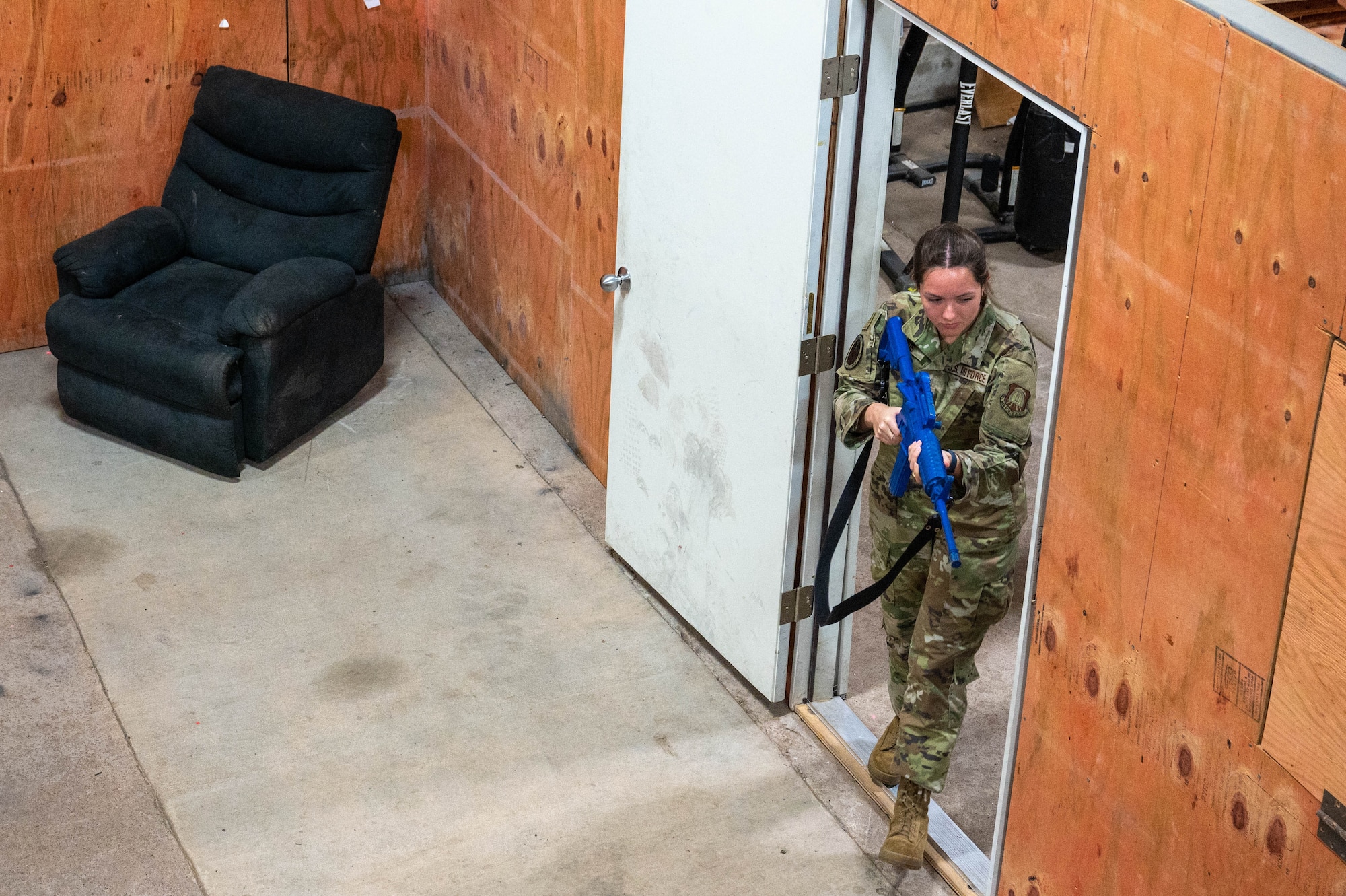 Madison Campos, Air Force ROTC cadet, enters a shoot house during a tour at Altus Air Force Base, Oklahoma, March 15, 2024. Campos gained hands-on experience using a rubber M-4 aid during the simulated exercise. (U.S. Air Force photo by Airman 1st Class Heidi Bucins)