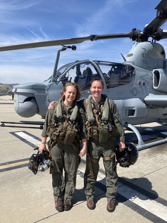 U.S. Marine Corps Captain Amy LaRue, left, an AH-1Z Viper pilot with Marine Light Attack Helicopter Squadron (HMLA) 367, 3rd Marine Aircraft Wing poses for a photo in front of an AH-1Z Viper. LaRue is a native of California. (Courtesy photo)
