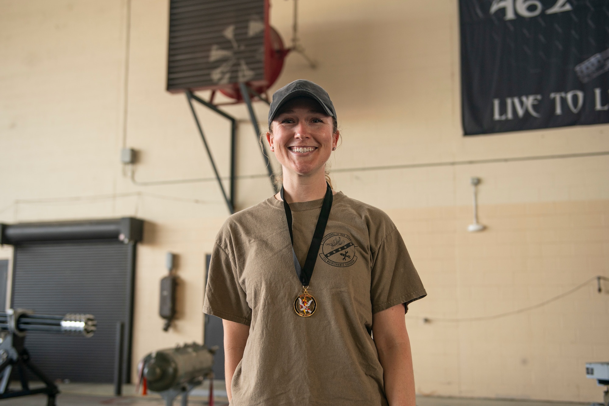 An Airmen smiles for a photo with a medal