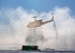 A Bell UH-1H helicopter departs Ice Camp Whale during Operation Ice Camp.
