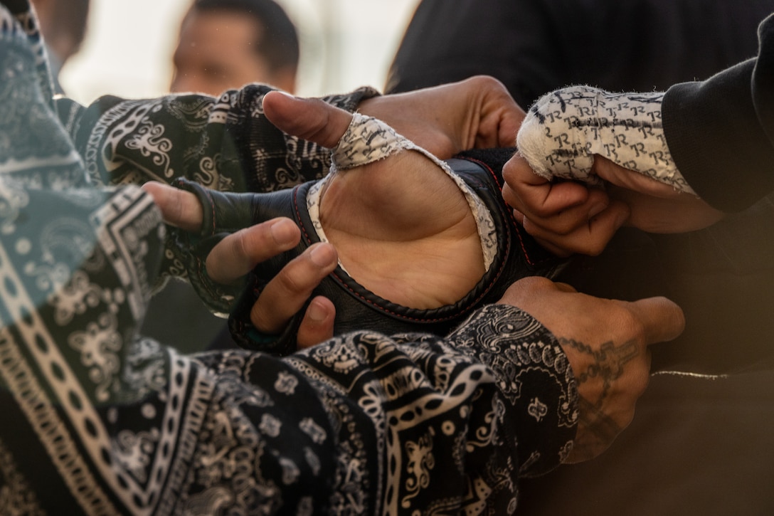 Aidan Salazar, an amateur fighter with Xtreme Couture, prepares for an MMA Fight Night held at the School of Infantry-West parade deck at Marine Corps Camp Pendleton, California, March 15, 2024. The MMA Fight Night consisted of amateur fighters going head-to-head in eight sanctioned bouts. This event was coordinated by Marine Corps Community Services Camp Pendleton to promote base cohesion, increase morale, provide entertainment, and to prioritize quality of life for Marines, Sailors, and families. (U.S. Marine Corps photo by Lance Cpl. Mhecaela J. Watts)