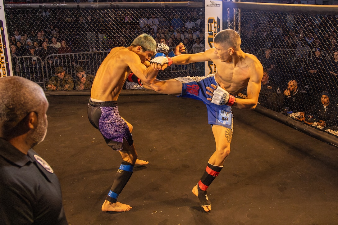 Moises Oslin, right, an amateur fighter with Team Overtime, kicks his opponent during an MMA Fight Night held at the School of Infantry-West parade deck at Marine Corps Camp Pendleton, California, March 15, 2024. The MMA Fight Night consisted of amateur fighters going head-to-head in eight sanctioned bouts. This event was coordinated by Marine Corps Community Services Camp Pendleton to promote base cohesion, increase morale, provide entertainment, and to prioritize quality of life for Marines, Sailors, and families. (U.S. Marine Corps photo by Lance Cpl. Mhecaela J. Watts)