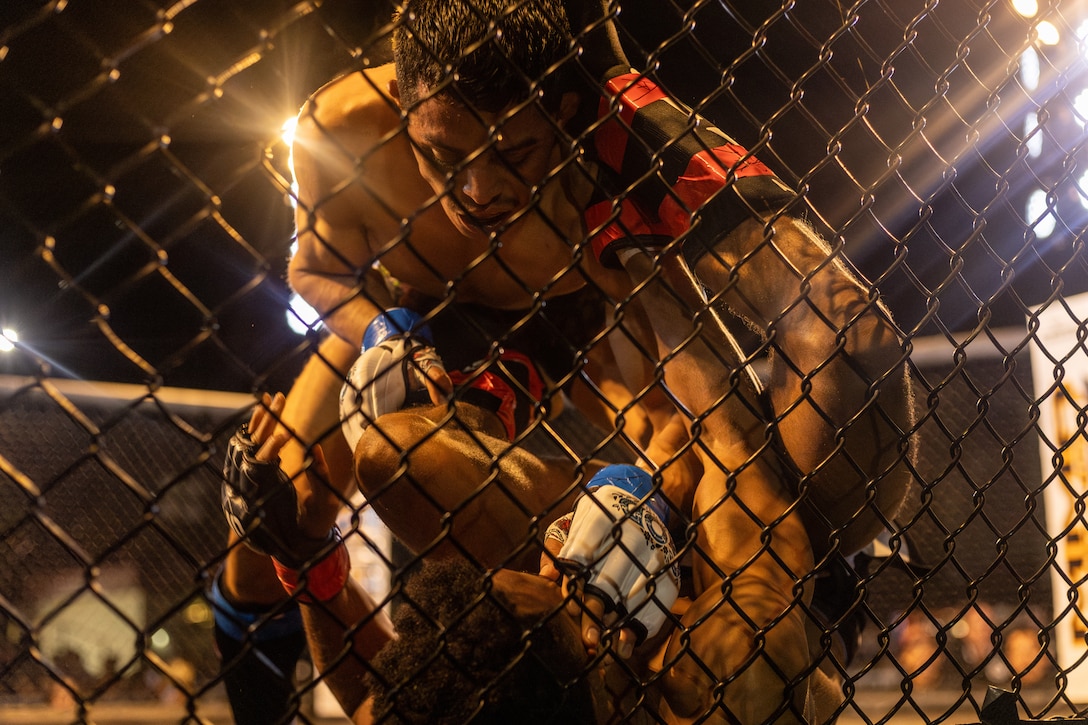 Daniel Sanchez, an amateur fighter with 10th Planet Jiu Jitsu, participates in an MMA Fight Night held at the School of Infantry-West parade deck at Marine Corps Camp Pendleton, California, March 15, 2024. The MMA Fight Night consisted of amateur fighters going head-to-head in eight sanctioned bouts. This event was coordinated by Marine Corps Community Services Camp Pendleton to promote base cohesion, increase morale, provide entertainment, and to prioritize quality of life for Marines, Sailors, and families. (U.S. Marine Corps photo by Lance Cpl. Mhecaela J. Watts)