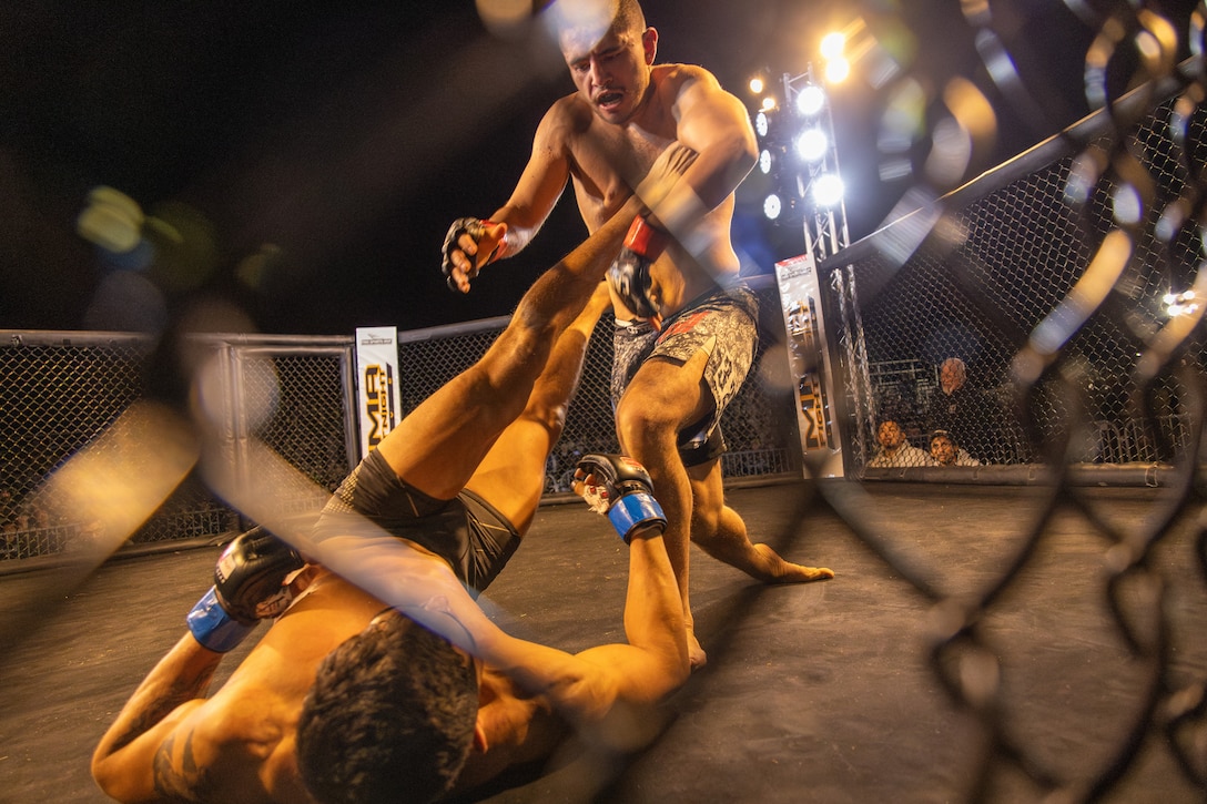 Amateur fighters participate in an MMA Fight Night held at the School of Infantry-West parade deck at Marine Corps Camp Pendleton, California, March 15, 2024. The MMA Fight Night consisted of amateur fighters going head-to-head in eight sanctioned bouts. This event was coordinated by Marine Corps Community Services Camp Pendleton to promote base cohesion, increase morale, provide entertainment, and to prioritize quality of life for Marines, Sailors, and families. (U.S. Marine Corps photo by Lance Cpl. Mhecaela J. Watts)