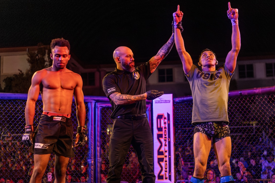 Daniel Sanchez, right, an amateur fighter with 10th Planet Jiu Jitsu, has his hand raised during an MMA Fight Night held at the School of Infantry-West parade deck at Marine Corps Camp Pendleton, California, March 15, 2024. The MMA Fight Night consisted of amateur fighters going head-to-head in eight sanctioned bouts. This event was coordinated by Marine Corps Community Services Camp Pendleton to promote base cohesion, increase morale, provide entertainment, and to prioritize quality of life for Marines, Sailors, and families. (U.S. Marine Corps photo by Lance Cpl. Mhecaela J. Watts)