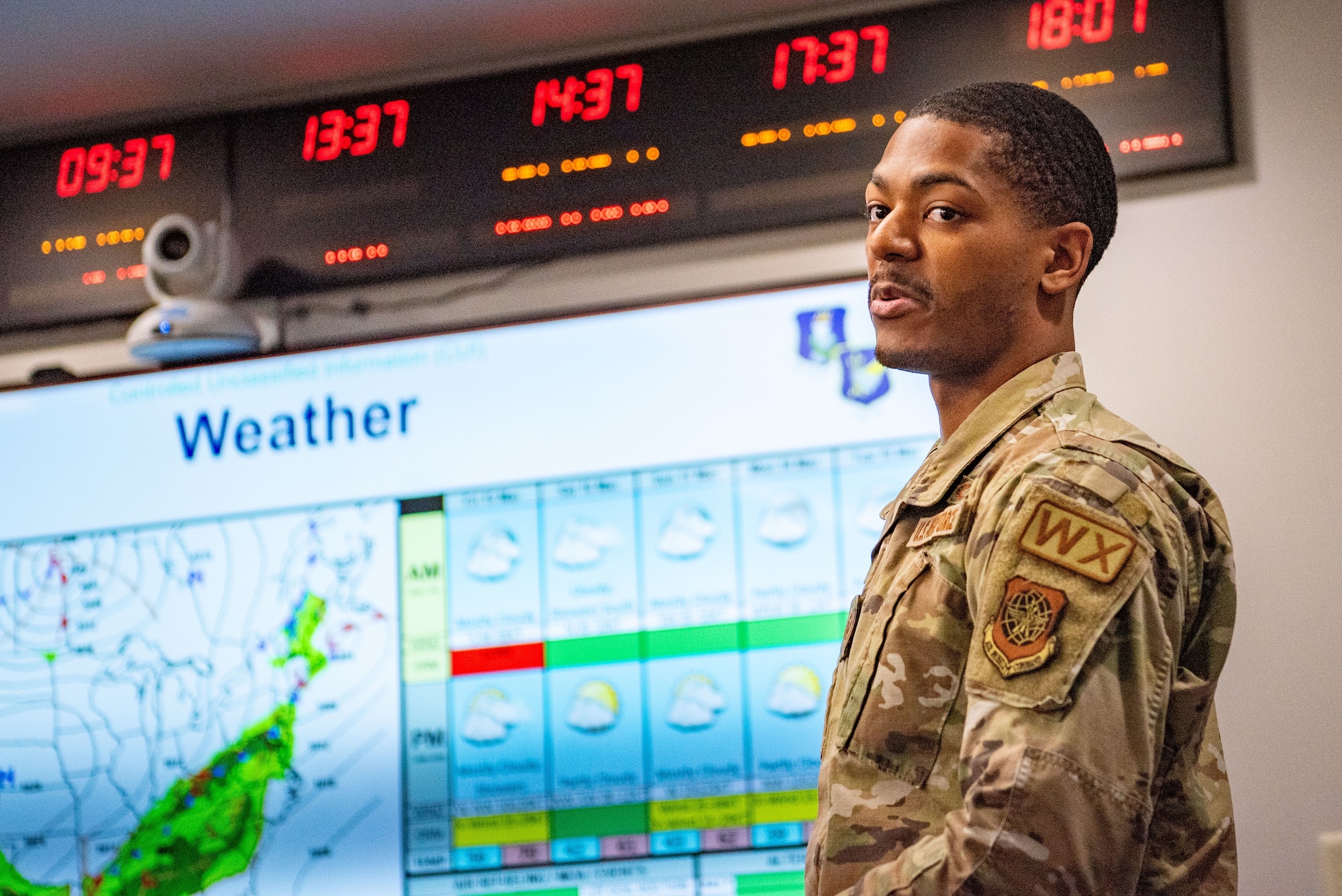 U.S. Air Force Staff Sgt. Drexter Bethea, 305th Operations Support Squadron weather craftsman, briefs the weather forecast to 305th Air Mobility Wing leadership during a weekly mission review at Joint Base McGuire- Dix-Lakehurst, N.J., March 15, 2024. Weather technicians provide intel to assist in determining mission viability and impacts. (U.S. Air Force photo by Jewaun Victor)