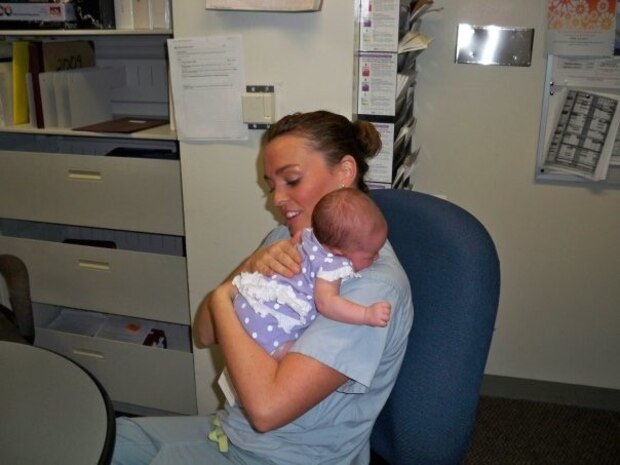 U.S. Air Force Lt. Col. Danielle Merritt, currently serving as the 9th Operational Medical Readiness Squadron commander, holds Charlotte Nowlin, a baby she delivered when she was a lieutenant at Wilford Hall Birthing Center, Lackland Air Force Base, Texas, 2009.
