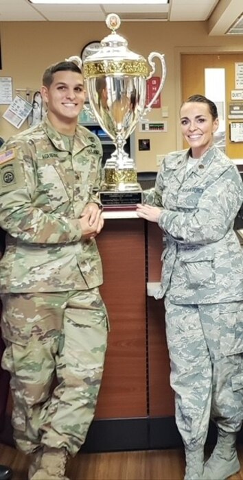 U.S. Air Force Lt. Col. Danielle Merritt, currently serving as the 9th Operational Medical Readiness Squadron commander (right), poses for a photo with U.S. Army Staff Sgt. Adam Aguirre, Brooke Army Medical Center (BAMC) flight non-commissioned officer in charge, after winning the BAMC Troop Commander’s Cup for outstanding patient care at Fort Sam Houston, Texas, 2018.