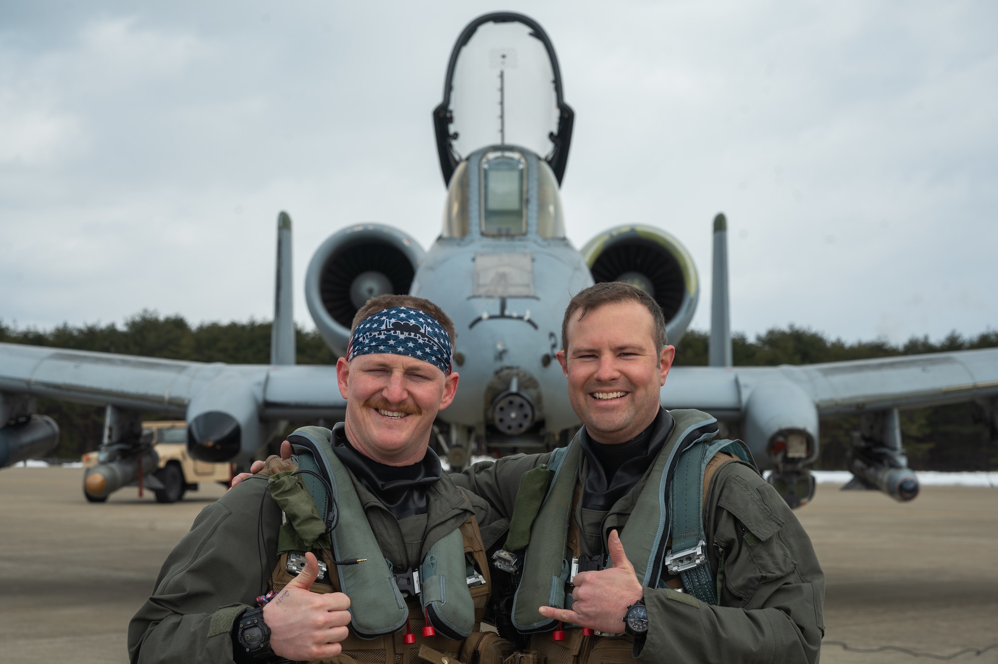 U.S. Air Force Capt. Jacob Stafford, 25th Fighter Squadron A-10C Thunderbolt II pilot, left, and Lt. Col. Justin Ledvina, 25th FS director of operations, pose for a photo during the Ninja Mustang training event at Misawa Air Base, Japan, March 7, 2024. Ninja Mustang is a training event within the Ninja Draggin series, where 51st FW Airmen relocate to collaborate with units across the Pacific. This initiative enhances the lethality and coordination of units within the pacific theater. During the training event, the two aircraft from the 25th Fighter Squadron successfully relocated to a different portion of the pacific area of responsibility, and to effectively delivered 12,000 lbs of simulated munitions to their targets. (U.S. Air Force photo by Airman 1st Class Chase Verzaal)
