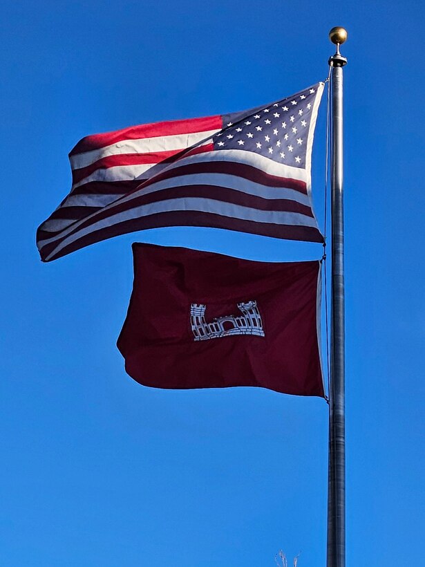 The American and USACE flags fly in the breeze in front of the Albuquerque District’s Office in Albuquerque, N.M., Feb. 15, 2024.