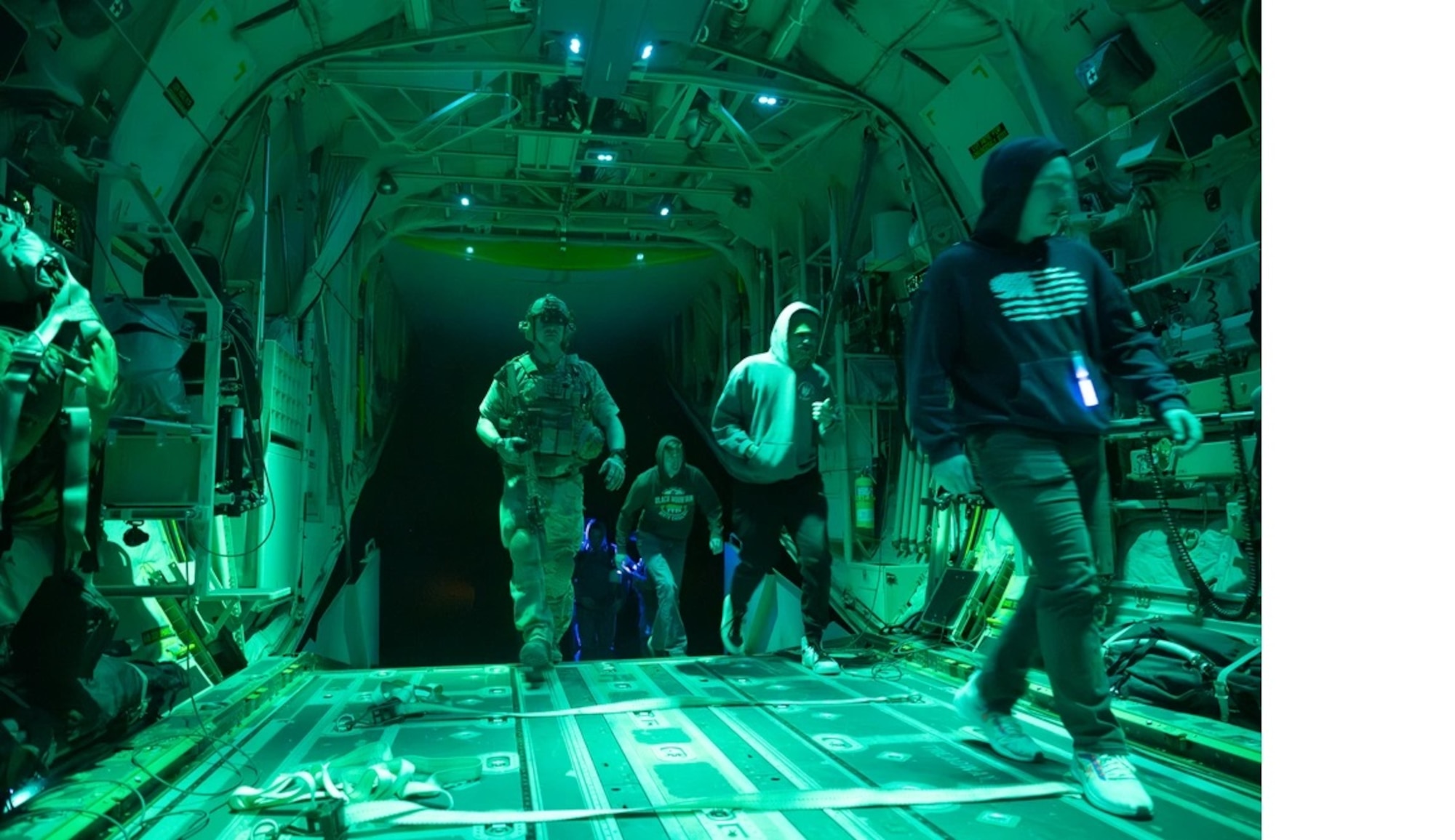 A Special Tactics Airman assigned to the 24th Special Operations Wing escorts simulated patients on board the MC-130J Commando II at Cannon Air Force Base, New Mexico on March 1, 2024. Supported by U.S. Special Operations Command, Emerald Warrior is a joint special operations exercise that prepares U.S. Special Operations Command forces, Conventional Enablers, Partner Forces, and Interagency Elements to respond to various threats across the spectrum of conflict. (U.S. Air Force Photo by Senior Airman Natalie Vandergriff)