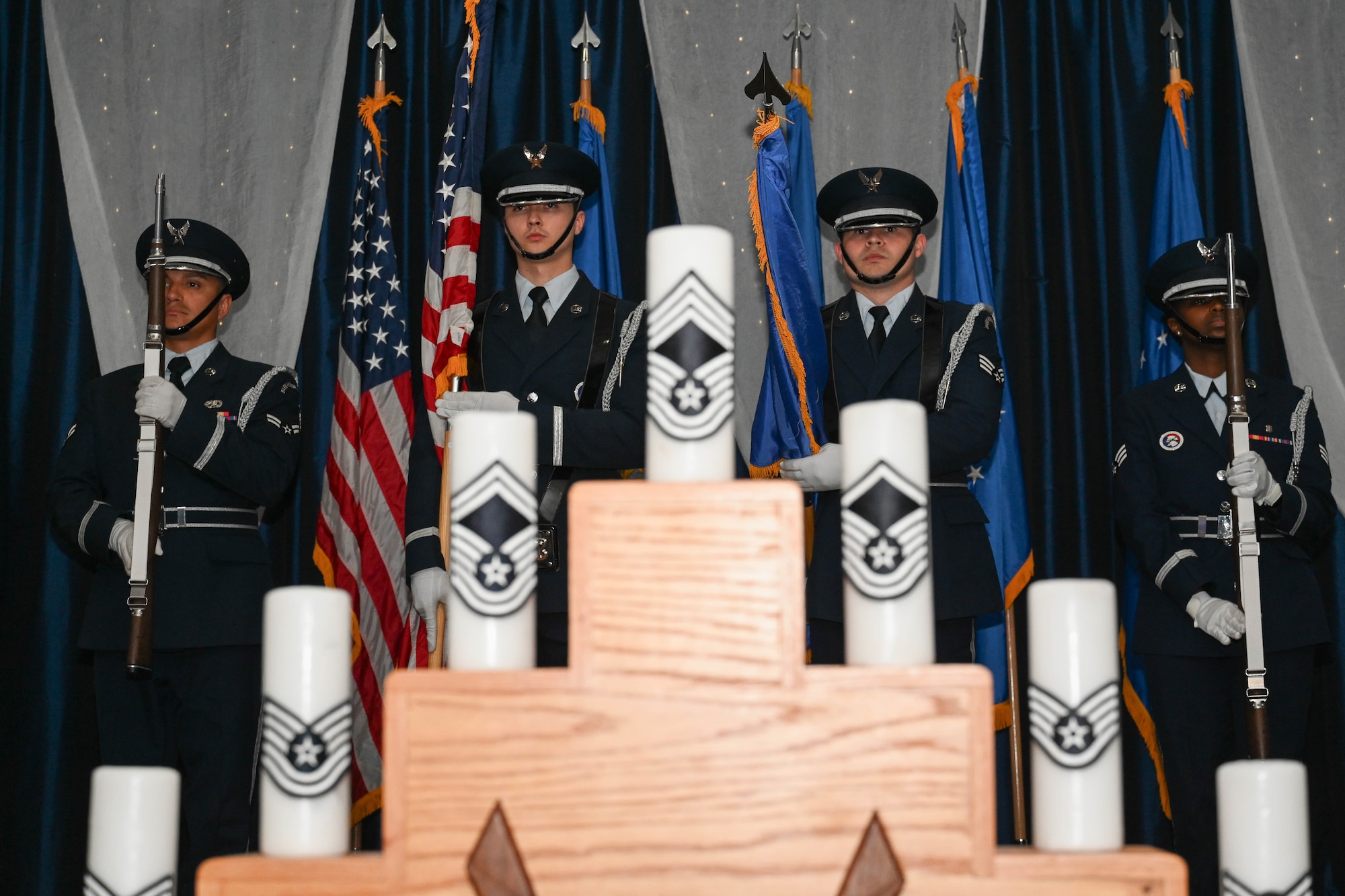 Barksdale Honor Guard stands on stage behind candles