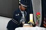 Airman places hat on missing man table