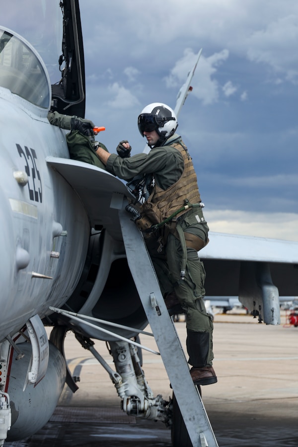 U.S. Marine Corps Capt. Michael Logrande, a student weapons systems officer with Marine Fighter Attack Squadron (VMFA) 323, Marine Aircraft Group 11, 3rd Marine Aircraft Wing, disembarks from an F/A-18D Hornet assigned to VMFA-323 after a section engaged maneuvering flight at Marine Corps Air Station Miramar, California, March 18, 2024. LoGrande conducted his final student flight with VMFA-323's Fleet Readiness Detachment before graduating on March 22, 2024, as the Marine Corps last WSO. (U.S. Marine Corps photo by Sgt. Sean Potter)