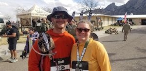 Joel Beuke, the National Security Space Institute security specialist, left, poses for a photo with his wife, Kristen, right, after completing the 35th Annual Bataan Memorial Death March at White Sands Missile Range, N.M., March 16, 2024. (Courtesy photo)