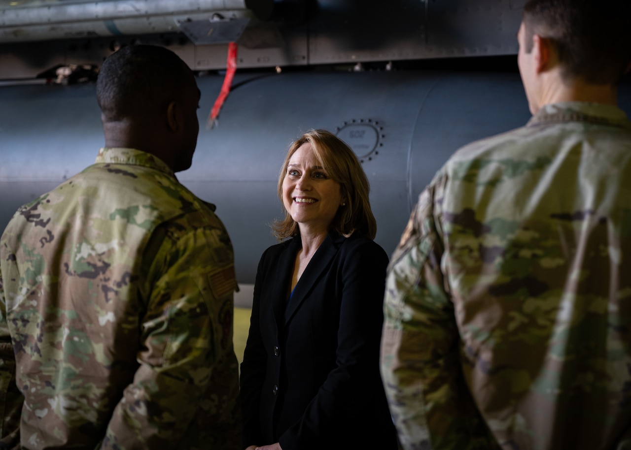 A woman speaks with troops.