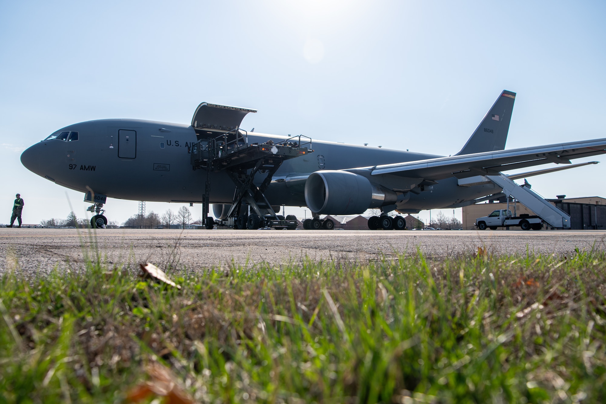 A Boeing KC-46 Pegasus jet aircraft sits on the runway to be loaded for aeromedical evacuation training.