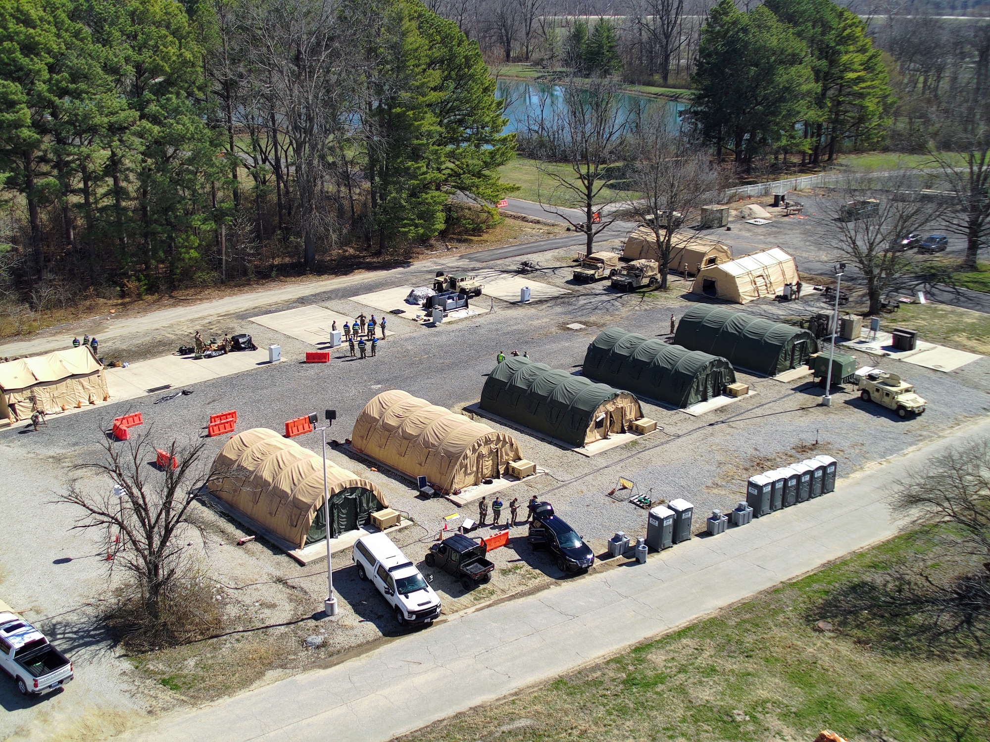 Airmen participate in a combined mobility and mission assurance exercise in the cantonment area with semi-permanent tents.