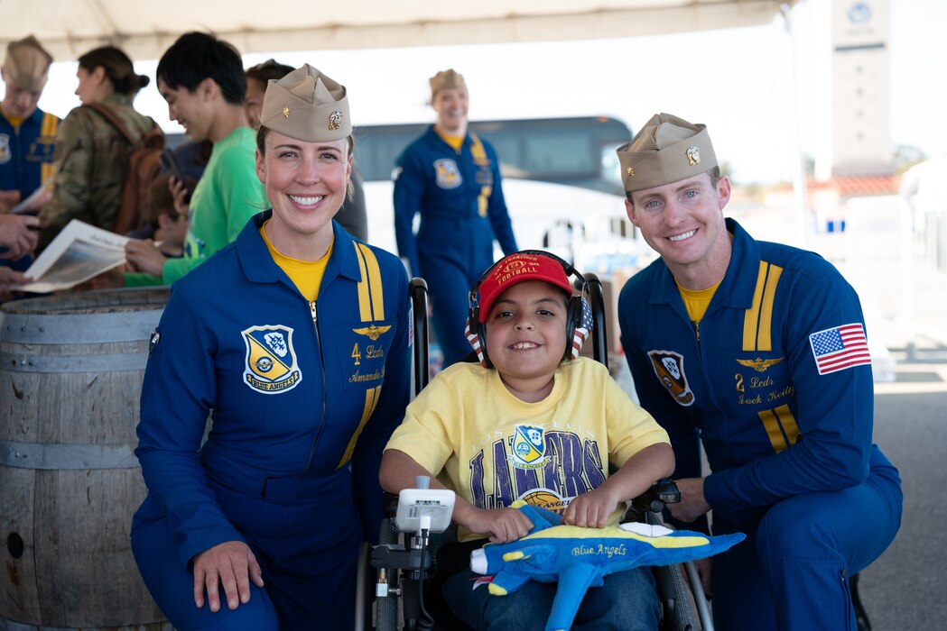 Blue Angels pilots take photo with a military child