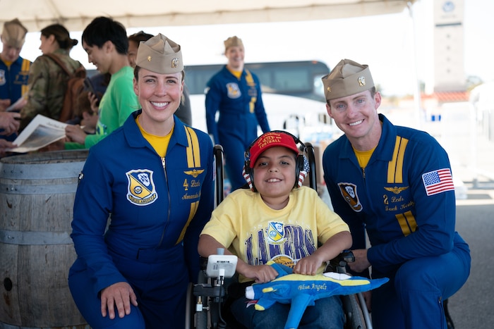 Blue Angels pilots take photo with a military child