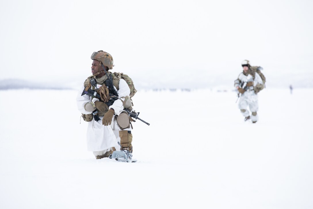 U.S. Army Staff Sgt. Ibn Alerou, squad leader, Commanche Company, 1st Battalion, 501st Parachute Infantry Regiment, 2nd Infantry Brigade Combat Team (Airborne), 11th Airborne Division, takes a knee while snowshoeing over Lake Takvatnet following a static line jump during Arctic Shock 24 near Bardufoss, Norway, March 18, 2024. The jump follows an over-the-pole flight from Alaska, showcasing the 11th Airborne Division's capability to insert anywhere into the Arctic. (U.S. Army Photo by Sgt. Avery Cunningham)