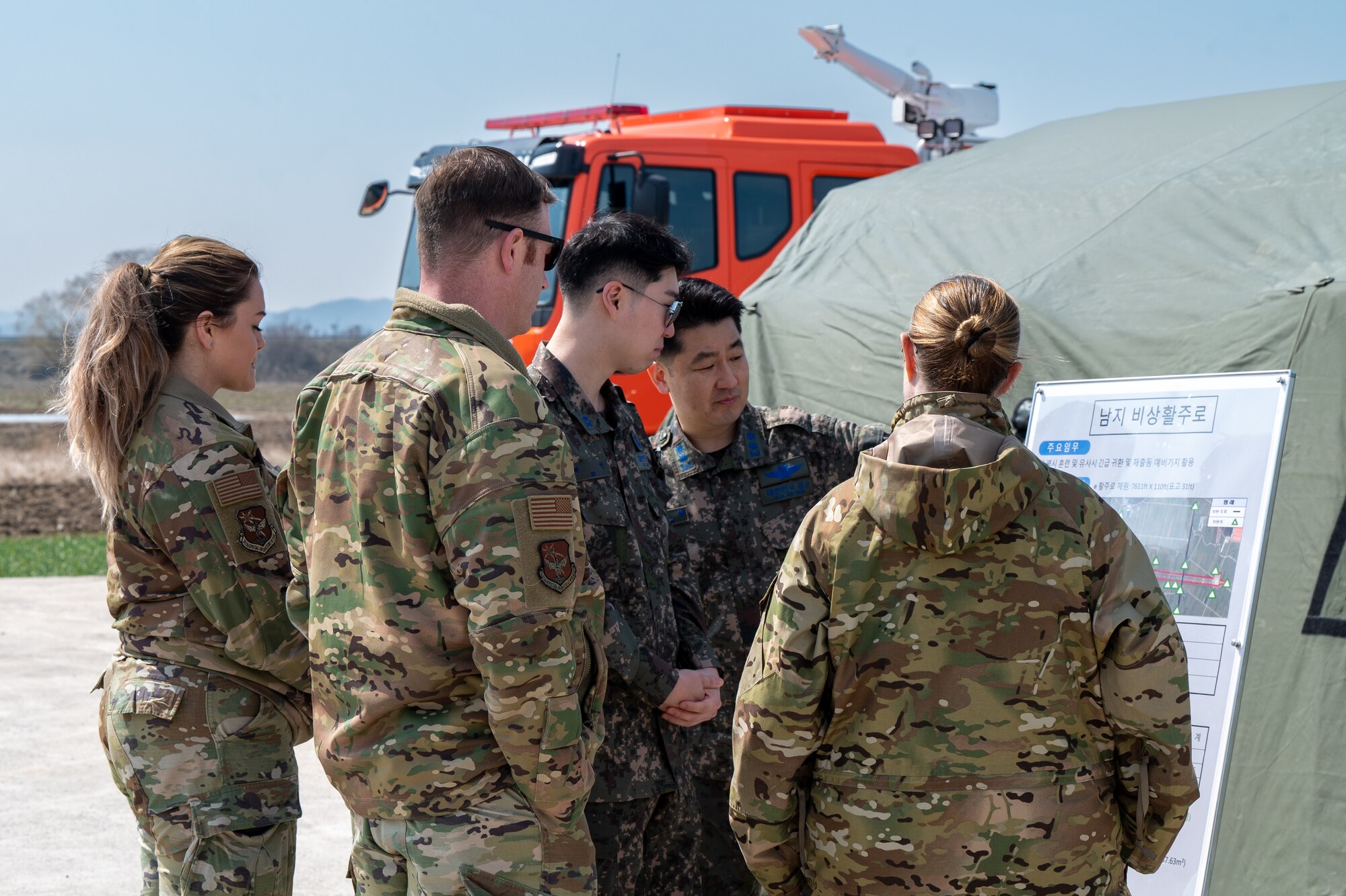 U.S. Airmen and Republic of Korea Air Force airmen open up exhibits to the public to share information about training being conducted at Namji, Republic of Korea, March 13, 2024. The training converted a public highway into an operational emergency landing strip. The training fostered a realistic operational environment, boosting the 51st FW's operational flexibility for rapid responses to threats in dynamic, contested areas. (U.S. Air Force photo by Senior Airman Brittany Russell)