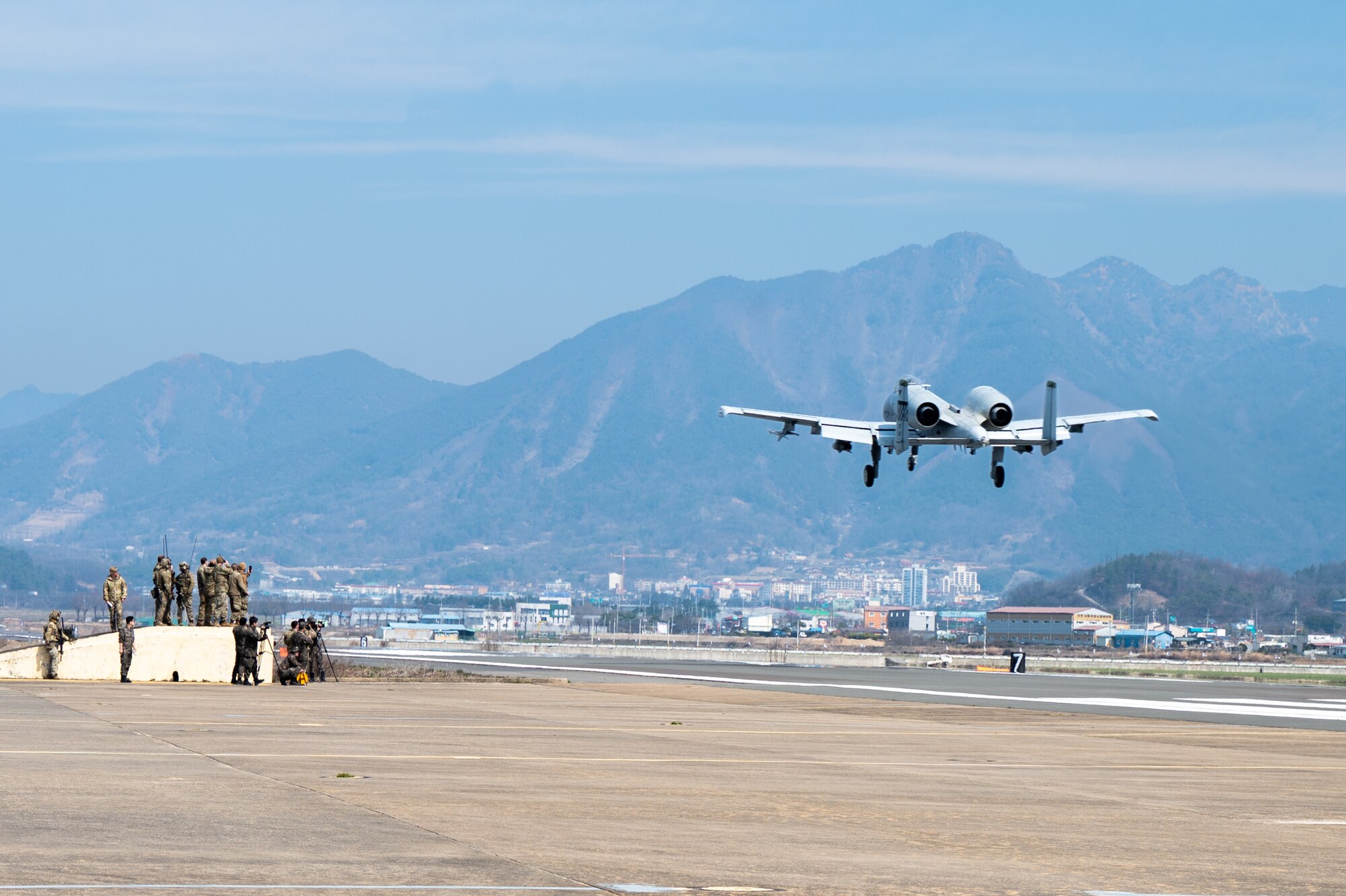 A U.S. Air Force A-10 Thunderbolt II assigned to the 25th Fighter Squadron flies over an emergency landing strip during routine training at Namji, Republic of Korea, March 13, 2024. The training brought together U.S. Army, Air Force, and Republic of Korea Air Force service members to train on agile combat employment capabilities. Mission ready Airmen of the 51st FW play a pivotal role in enabling ACE, allowing for rapid aircraft deployment and versatile operations from austere locations, ultimately enhancing the ability to respond effectively to dynamic mission requirements in contested environments. (U.S. Air Force photo by Senior Airman Brittany Russell)