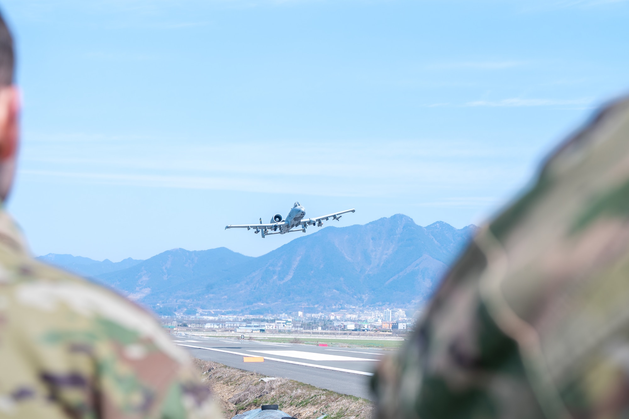 A U.S. Air Force A-10 Thunderbolt II assigned to the 25th Fighter Squadron flies over an emergency landing strip during routine training at Namji, Republic of Korea, March 13, 2024. The 51st Fighter Wing conducted agile combat employment training alongside multiple U.S. and South Korean military members from various bases. ACE ensures rapid deployment and versatile operational capabilities which are crucial in defending the Republic of Korea, by maintaining readiness to swiftly respond to evolving threats at a moments notice. (U.S. Air Force photo by Senior Airman Brittany Russell)
