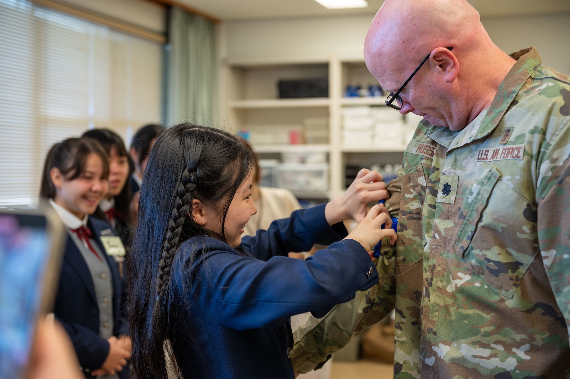 An Okinawan student places a tourniquet on U.S. Air Force Lt Col. Travis Russell, 18th Medical Group medical staff chief