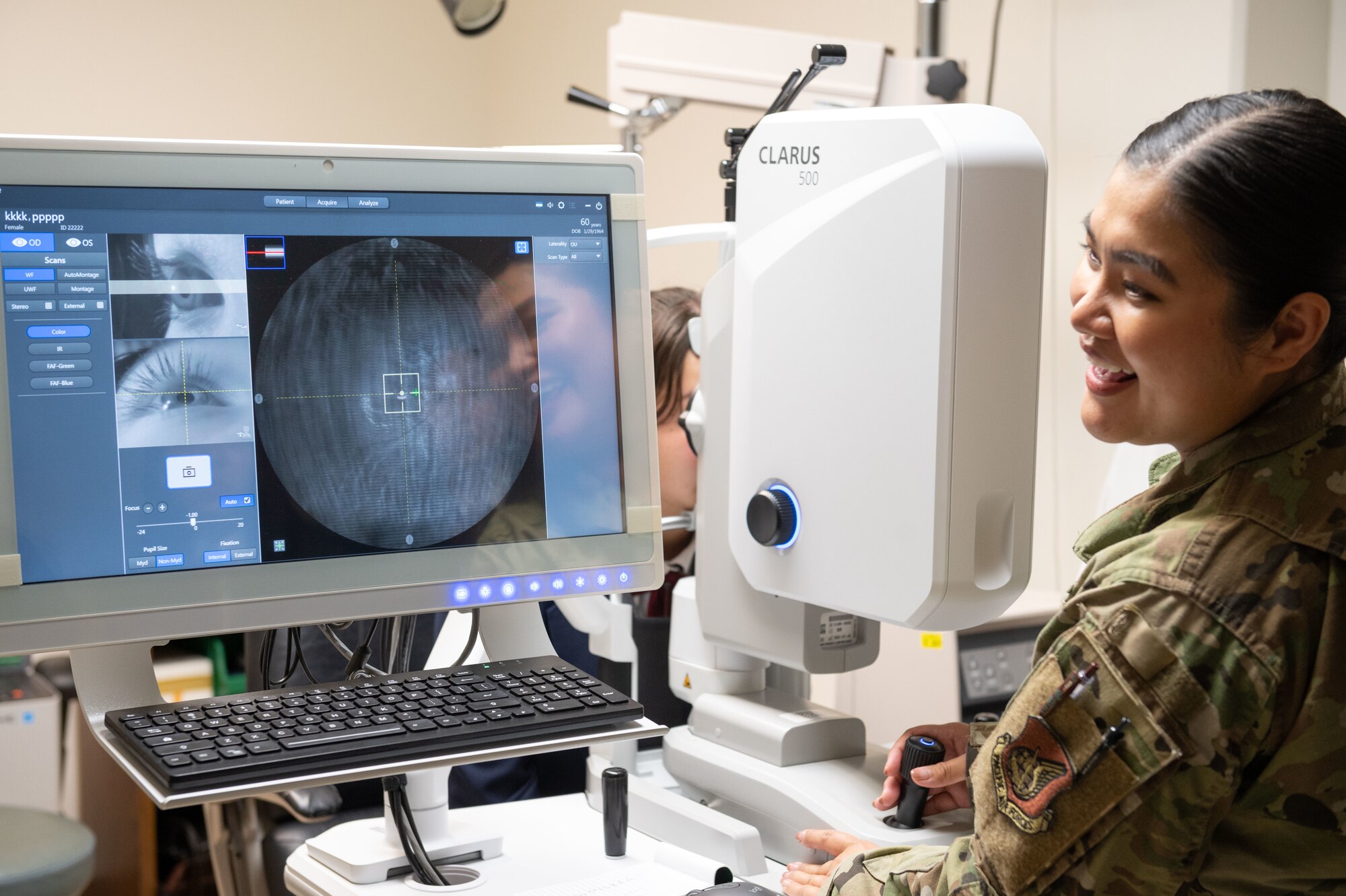 U.S. Air Force Master Sgt. Gemalyn Bonaobra, 18th Medical Group human performance flight chief, scans the eye of an Okinawan student